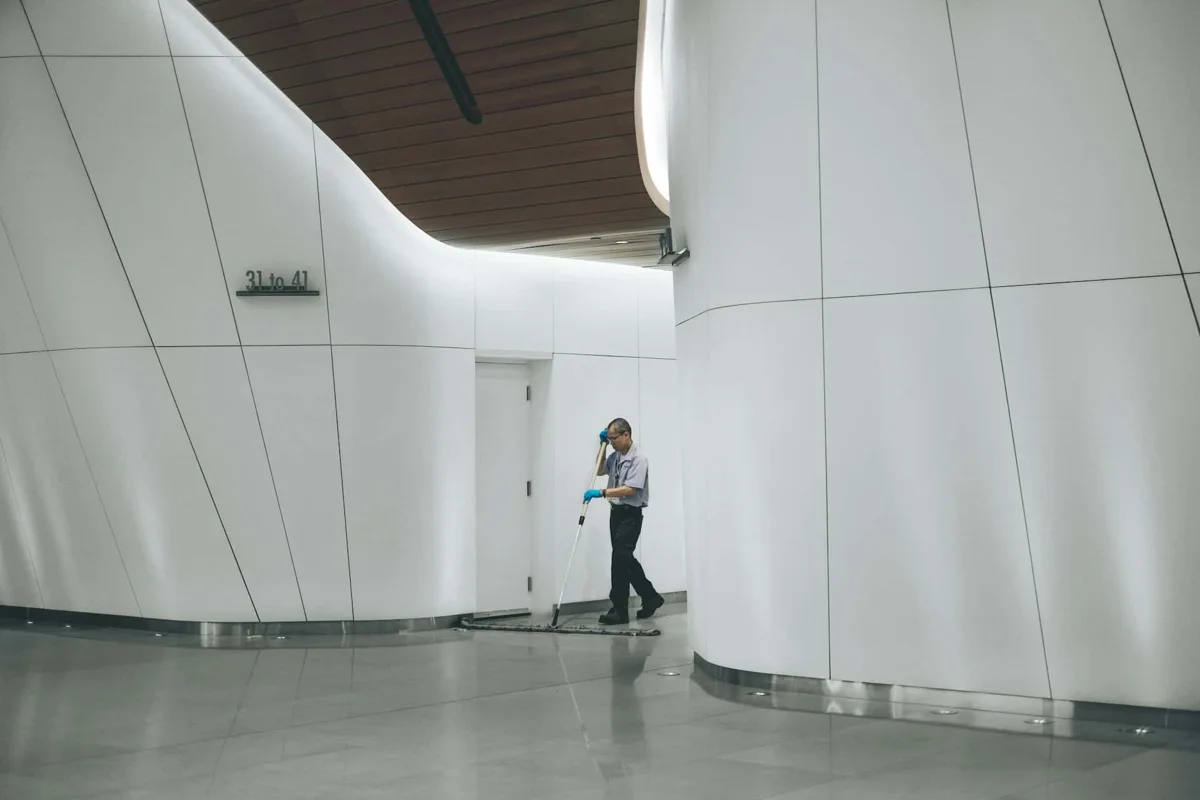 Cleaner working in a large commercial corridor
