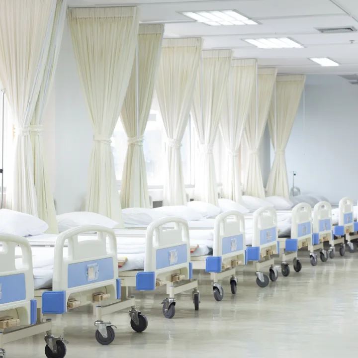 Patient care room with beds and privacy curtains