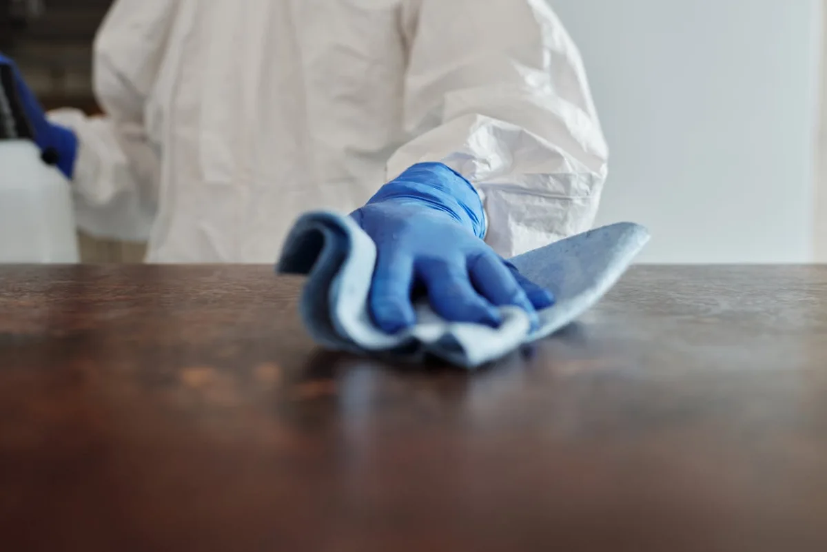 Cleaner wiping a work surface