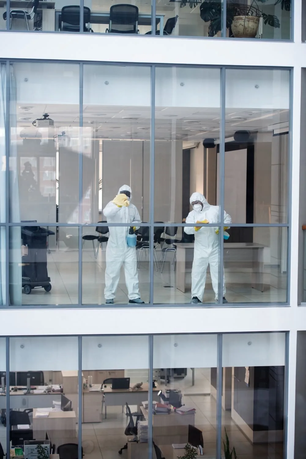 Cleaning team working around interior glass